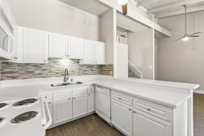 Apartments for Rent in Garden Grove, CA - Park Grove Kitchen with white appliances and modern dark wood cabinets