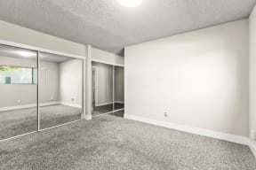 Park Grove Apartments in Garden Grove, CA with Wall to wall carpet, large mirrored closets, and neutral walls