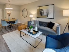 Spacious Living Room With Plank Flooring at The MilTon Luxury Apartments