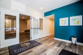 Lobby with First Point Management Matt over Wood Inspired Floor, Turquoise Walls and Empty Room with Open Windows
