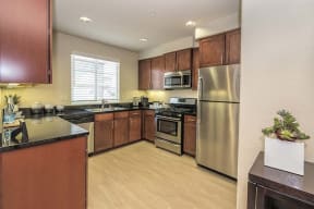 Apartments for Rent in Roseville, CA - Adora Kitchen with stainless steel appliances, and modern dark wood cabinets
