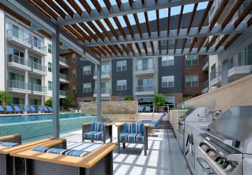 outdoor lounge with grills next to pool