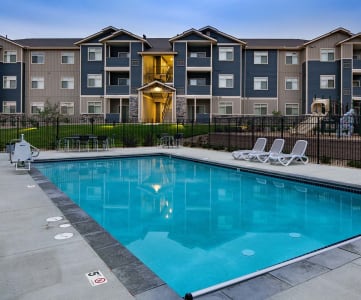 Pool with lounge chairs and apt buildings Apartments For Rent in Olympia, Washington  l Copper Trail 