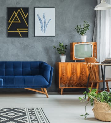Living room with blue couch, art, and vintage decor