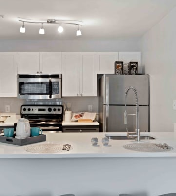 Kitchen with two tone cabinets and stainless steel appliances