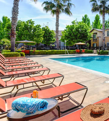 Pool with lounge chairs l Eaton Village Apartments in Chico CA 