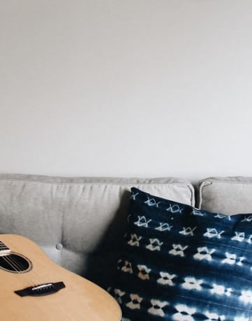 Stock photo of guitar on sofa