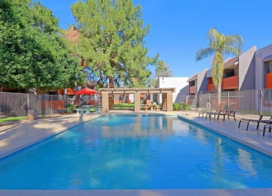 Apartments North Phoenix for Rent - Sierra Pines - Pool Area with Lounge Chairs, Tables, and Umbrellas