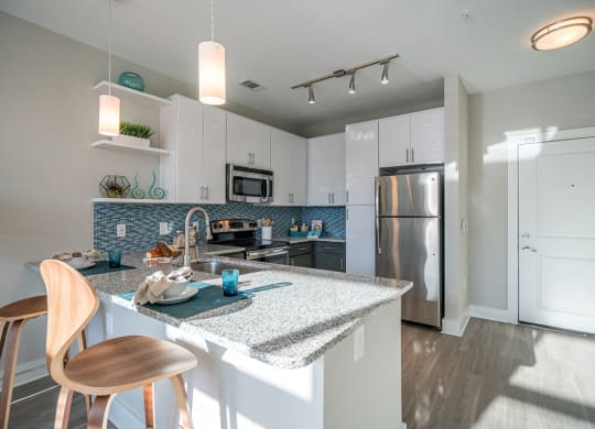 Fitted Kitchen With Island Dining at Link Apartments® Glenwood South, Raleigh, NC, 27603