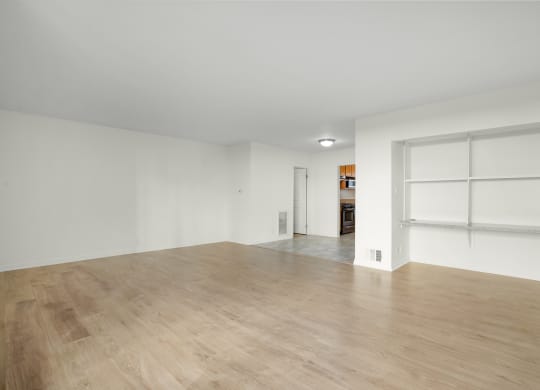 Apartment living room with built in cabinets and dining area