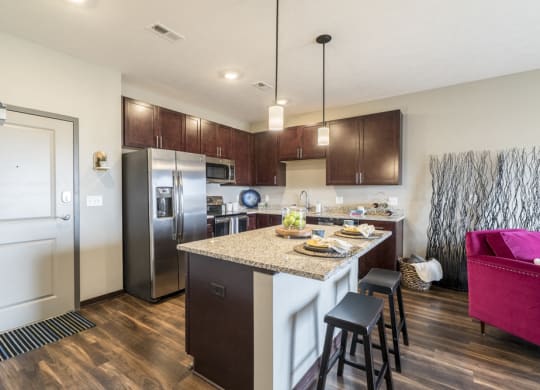 One bedroom apartment kitchen with dark cabinetry and stainless steel appliances at 360 at Jordan West best new apartments West Des Moines IA 50266