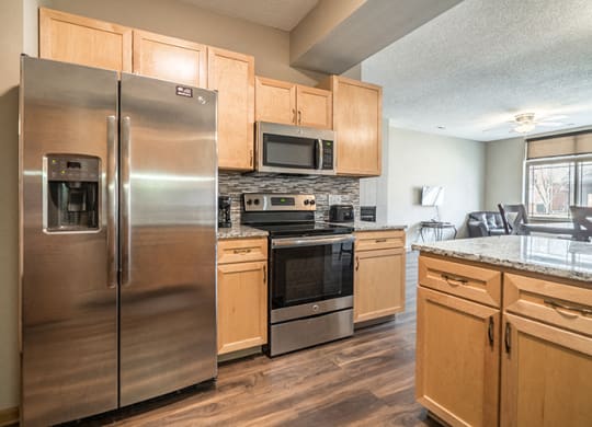 Upgraded unit with side-by-side stainless steel fridge and appliances at Southwind Villas townhomes in La Vista, NE, 68128