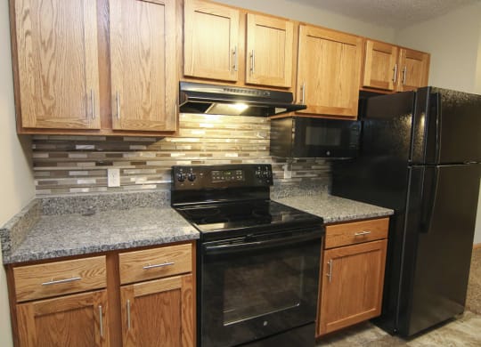 Renovated kitchen with granite counters and new appliances at The Northbrook