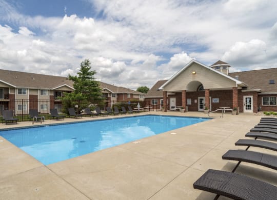 Large outdoor pool with lounge chairs at The Northbrook Apartments in Lincoln, NE 68504