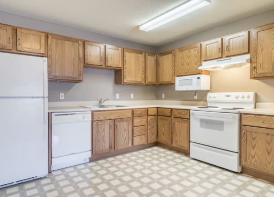 Kitchen with white appliances and lots of cabinet storage at Northridge Heights in north Lincoln