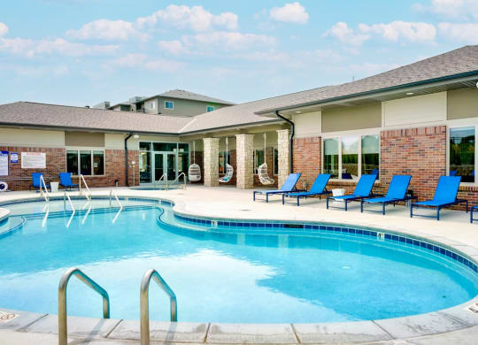 Resort style pool with lounge chairs outside the clubhouse at The Flats at Shadow Creek