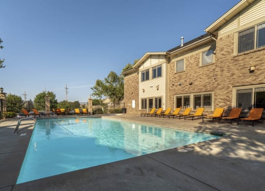 View of clubhouse with swimming pool  at Grand Legacy apartments and townhomes in west Omaha NE 68130