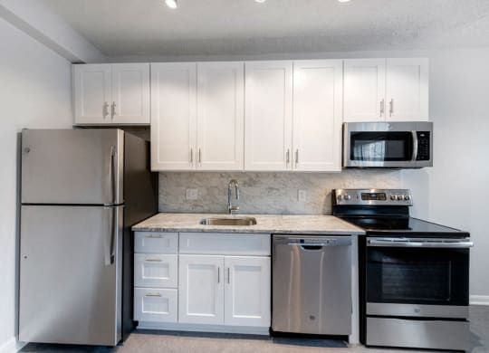 Stainless Steel Kitchen and White Cabinets at Connecticut Plaza Apartments, Washington, District of Columbia.