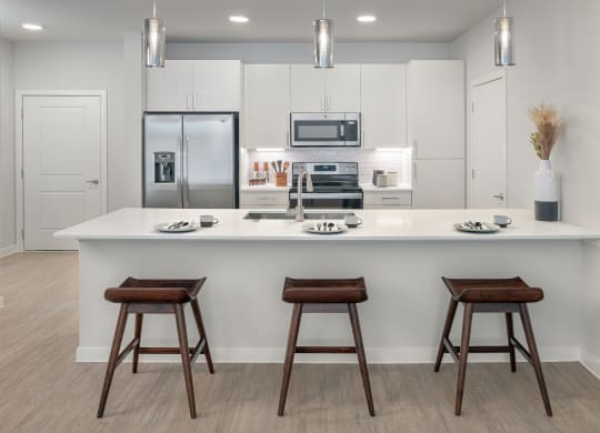 Stunning kitchens feature quartz countertops and subway tile backsplash at Windsor South Congress, Austin, 78745