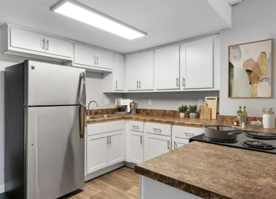 Model kitchen with white cabinetry