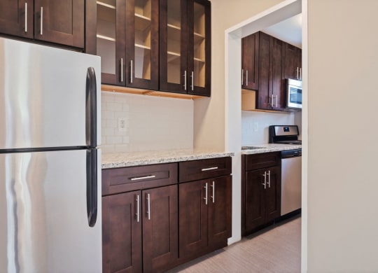Renovated kitchen with granite countertops and stainless steel appliances at 2100 Connecticut, Washington, DC