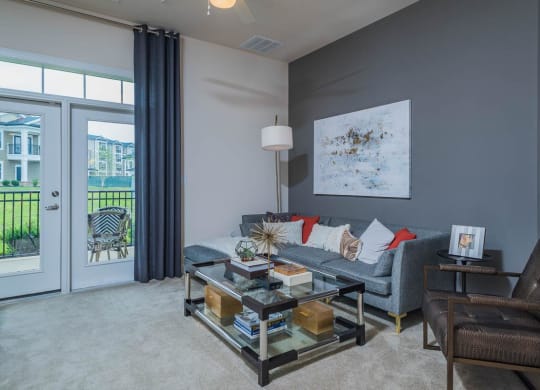 Spacious Living Room With Private Balcony at Abberly Waterstone Apartment Homes by HHHunt, Virginia, 22554