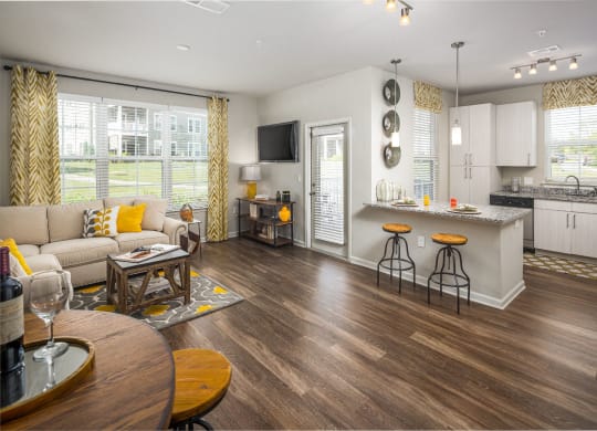 Living room with kitchen space at Abberly Market Point Apartment Homes, Greenville, South Carolina
