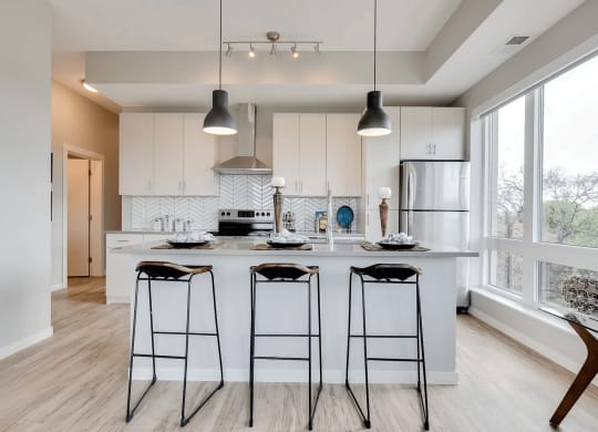 Spacious Kitchen Island with Stylish Pendant Lights at The Whit, Minnesota, 55404