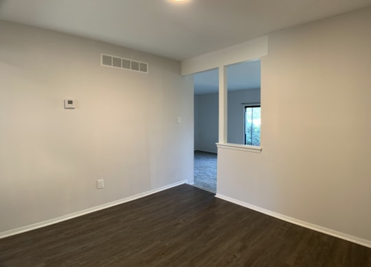 Open spacious dining room with dark hardwood floors