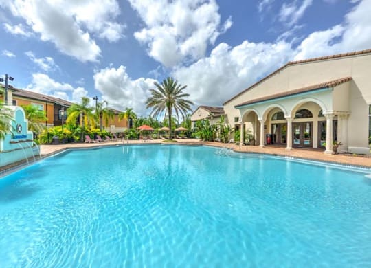 a large swimming pool with a building in the background