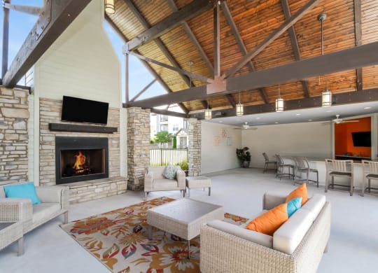 Copperfield apartments outdoor covered living area with fireplace and comfortable seating