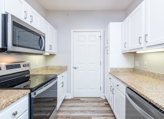 Drum Hill 2 Bedroom Apartment Kitchen with stainless steel range and microwave, granite counters, stainless dishwasher