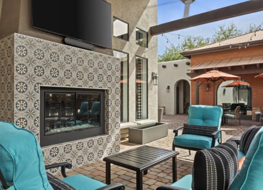 Lazo Apartments Outdoor Seating Area by Fireplace