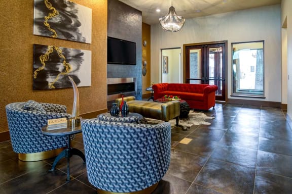 Clubhouse Living Room with Television and Fireplace at The Retreat Apartment Homes, Williston, ND