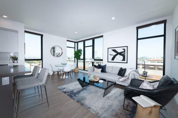 a living room with white walls and hardwood flooring