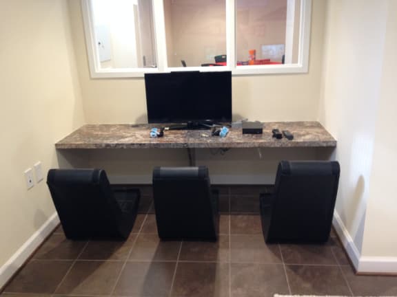 resident gaming station with monitor, game controllers, and fun chairs at fairway park apartments in washington dc