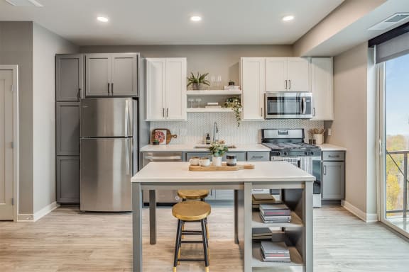 The Asher apartments kitchen with island and stainless steel appliances