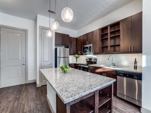The Crosby at The Brickyard modern kitchen with granite countertops and wooden floors