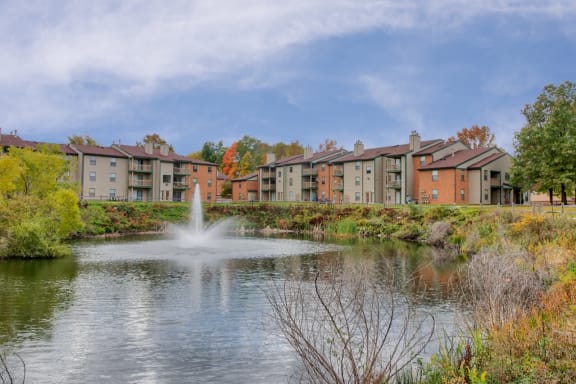 Lush grounds with pond at Hunt Club Apartments, Integrity Realty, 44321