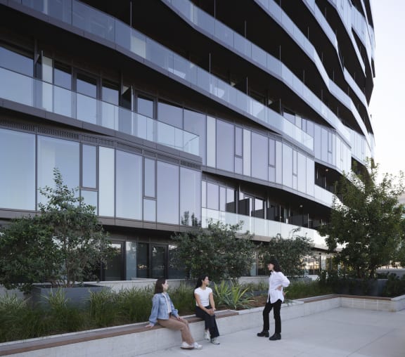 people sitting on a bench located at the 6th floor lounge
