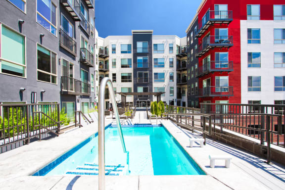Swimming pool with large tanning deck and native surrounding landscape