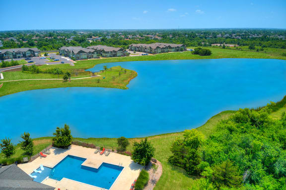 Aerial view of the pool area by a lake