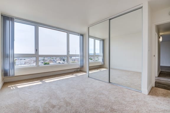 One-Bedroom Apartments in Downtown Oakland, CA - Merritt on 3rd Apartments Bedroom with Large Windows and Spectacular View