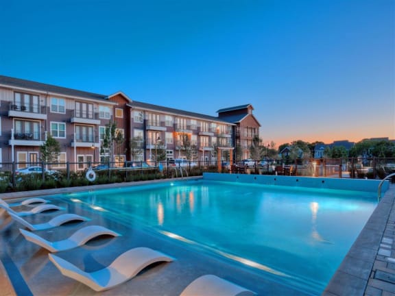 Rowlett TX Apartments - Village of Rowlett - Swimming Oasis with Resort-Style Pool, Sun Deck, and In-Pool Lounge Chairs