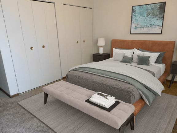 a bedroom with a bed and a bench in front of it