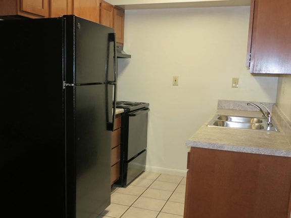 apartment kitchen with stove and refrigerator