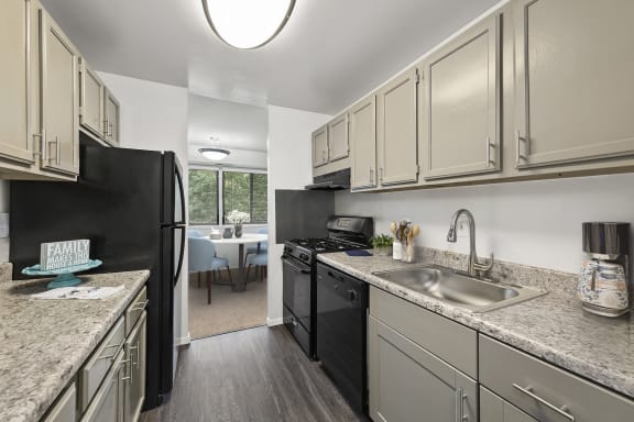 kitchen at Seven Springs apartments in College Park MD with new black appliances and light gray cabinets