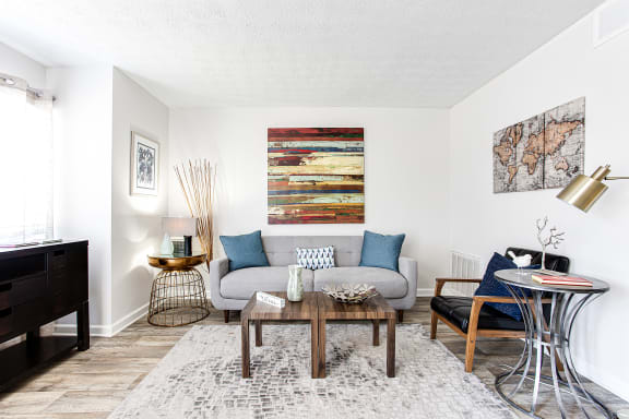 Gorgously renovated living space featuring wood like flooring at Brookfield Park Apartments, Conyers, GA 30012