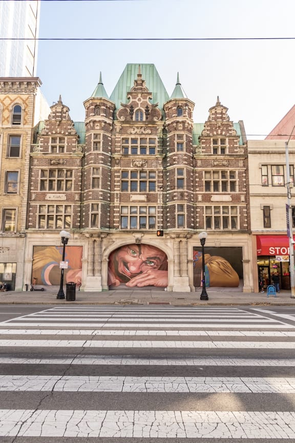 Street view of apartment building with the mural of the giant- The Arts Lofts at Dayton Arcade, Dayton, OH - Kevin Lush Photography
