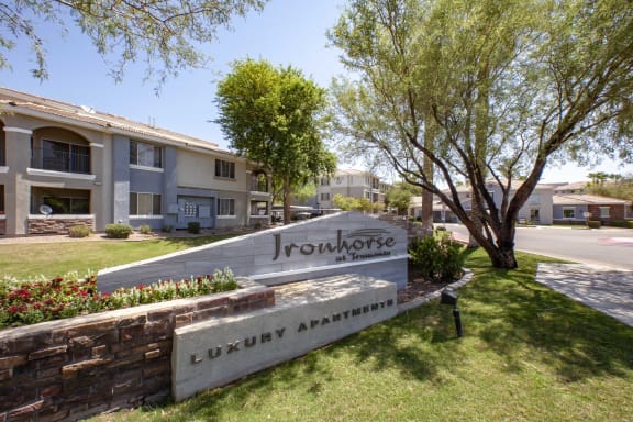 Apartments in North Phoenix AZ for Rent - Exterior View of Ironhorse at Tramonto Apartments Building Showcasing Entrance Sign and Expansive Community